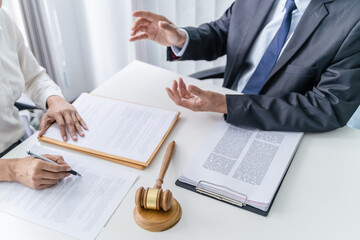 Legal counsel presents to the client a signed contract with gavel and legal law. justice and lawyer concept