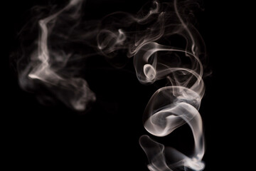 Abstract movement of smoke on dark background. Concept of alternative non-nicotine smoking. Blurry image warm toned vape smoke. Electronic Cigarette. Evaporator. Soft focus. Streaming.