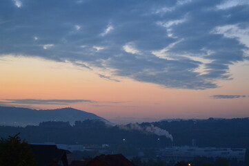 sunrise over the city and the factory in the distance