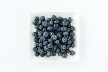 Top View of Fresh Blueberries on a Square Plate isolated on White