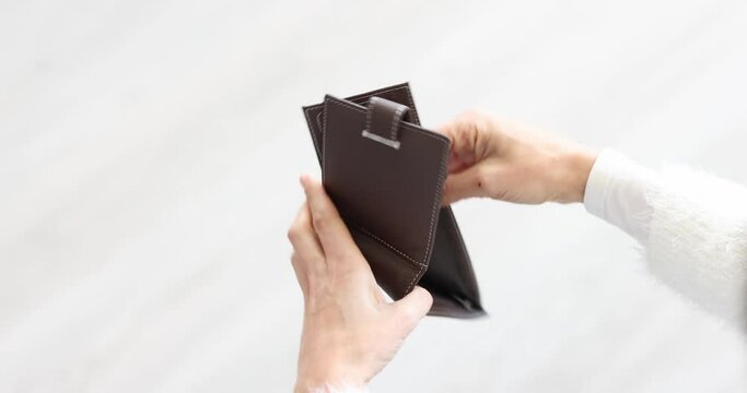 Woman looks into empty wallet and throws it on floor slow motion 4k movie