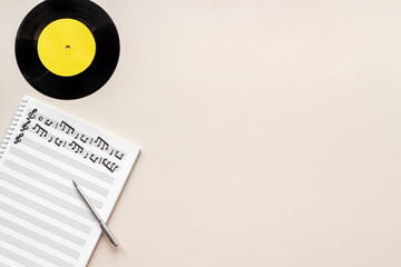 Sheets with music notes and vinyl record. Compose music concept