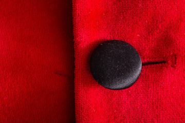 Red stylish jacket with buttons, background. Stylish clothes, macro, elegant