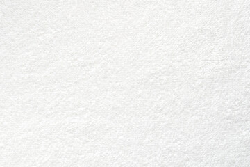 Smooth white towel, close-up of soft towel as texture or background, top view