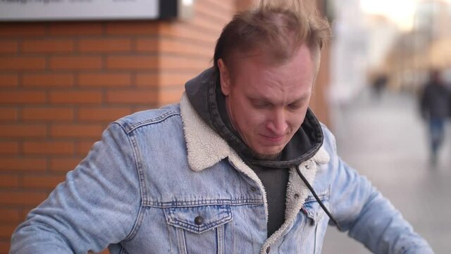 A dancing man in a city block. Slow motion