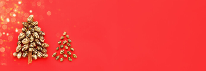 New Year and Christmas card. Two decorative Christmas tree made from golden cones on a red background. Banner. Minimal New Year concept