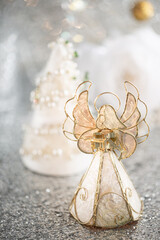 Christmas decorative nacreous toy angel with a book in his hands and a white beautiful background...