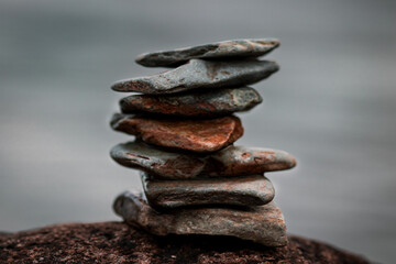 A macro photograph of a small tower of stones along the shoreline of Crummock Water in the Lake district, Cumbria.