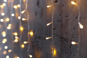 garland of light bulbs on the wall of bokeh new year