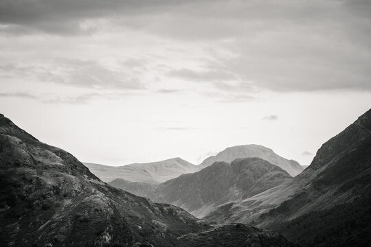 A monochrome landscape photograph of the southern fells of Buttermere Valley in The Lake District, Cumbria.