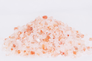Himalayan pink crystal salt with a slide on a white background