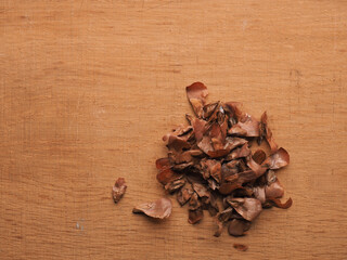 Seeds of a Nordmann fir on a wooden background, space for text, Christmas tree seeds