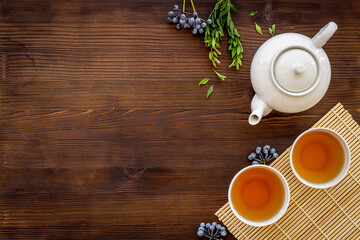 Tea ceremony with with white teapot and two cups, top view