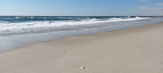 The excitement of the sea against the background of a clear blue sky. October, seaside.