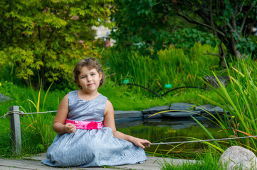 little girl sitting on the grass