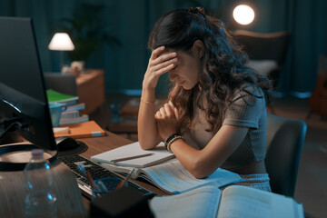 Depressed stressed woman sitting at desk