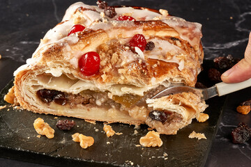 fork cutting piece of apple strudel with filling in sight