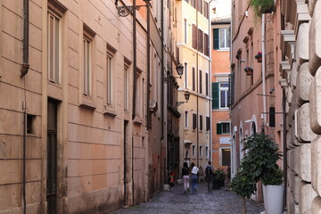 Fototapeta na wymiar Rome Street View with House Facades and Walking People, Italy