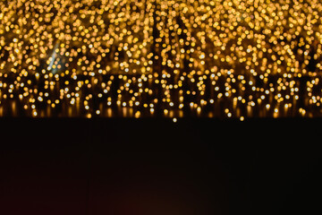 Naklejka premium Christmas lights. bokeh effect on black background. particles lights.