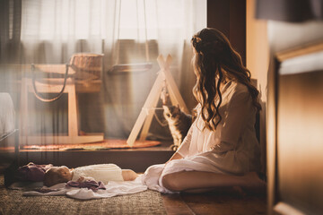 Magic tenderness photo of mother and little baby girl in the bedroom