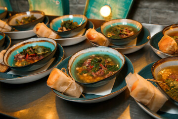 Freshly made aromatic chickpea and meat soup topped with parsley. 