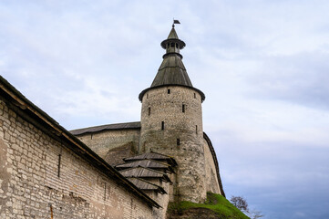 Fototapeta na wymiar Square round tower. kremlin towers. Pskov, fortress wall. A beautiful evening.