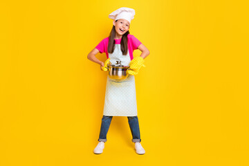 Photo of funny crazy little girl hold pot wear gloves white apron headwear isolated yellow color background