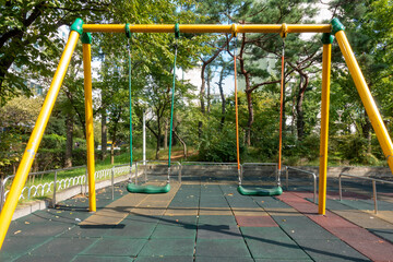 Metal colorful swings in the playground in the park