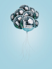 Creative party composition with flying balloons made with shiny disco balls on pastel blue background. Minimal Christmas or New Year eve celebration concept. Anniversary, nightclub or nightlife idea.