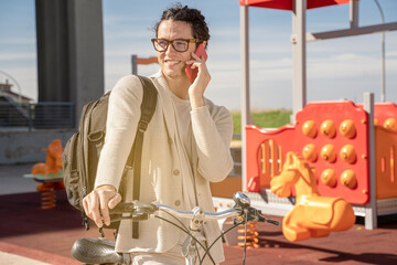 Fototapeta premium freelance man using mobile phone on bicycle