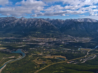 Beautiful aerial panoramic view of Bow Valley with town Canmore, Alberta, Canada in the Rocky Mountains with Rundle Forebay reservoir and forests.