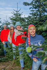 Outdoor Happy Family Choosing Christmas Tree Together