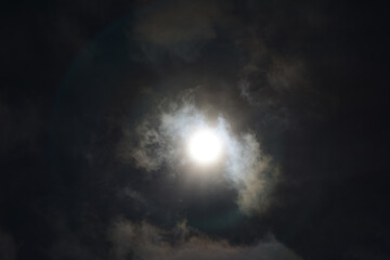 Naklejka na ściany i meble Partial solar eclipse with clouds