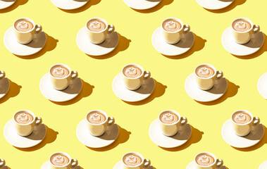 On a light yellow background, a pattern of white coffee cups. Wallpapers for phone or large print volumes