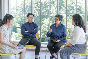 focus group of mental health by psychologist consultant. Asian people meeting together to talk problem and receive mental treatment. Senior doctor leader speaking to diversity man and woman patients.