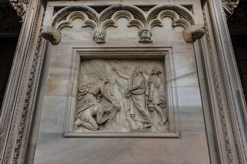 Architectural fragment of Milan Cathedral (Duomo di Milano, 1386), dedicated to St Mary of the Nativity (Santa Maria Nascente), with Gothic and Lombard Romanesque style. Milan, Italy.