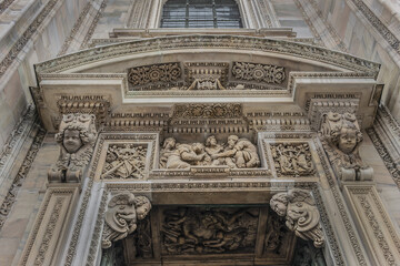 Obraz premium Architectural fragment of Milan Cathedral (Duomo di Milano, 1386), dedicated to St Mary of the Nativity (Santa Maria Nascente), with Gothic and Lombard Romanesque style. Milan, Italy.