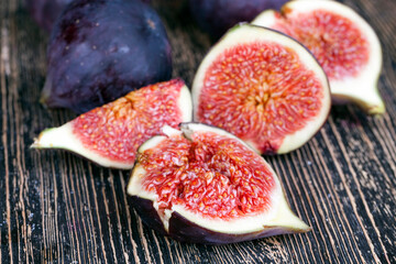 ripe purple figs on a wooden table