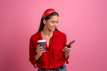 hispanic beautiful woman in red shirt smiling holding smartphone