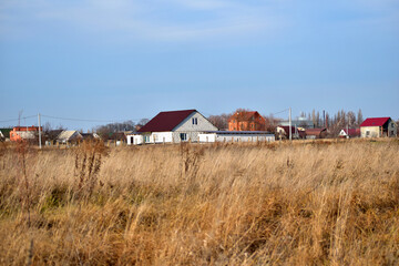 Yellow field and houses on the horizon.