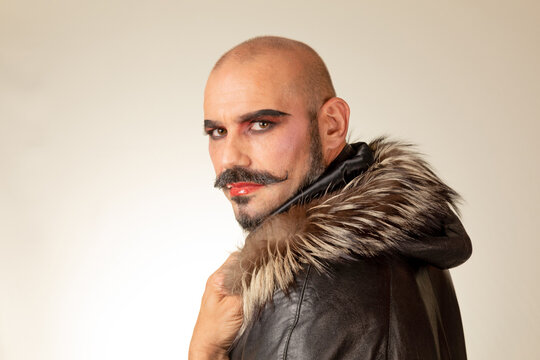 portrait of drag queen on isolet background. Man with red makeup and beard
