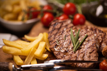 Grilled steaks, baked potatoes and vegetables