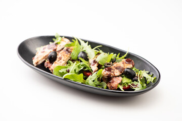 Closeup of a healthy chicken salad with olive and salas isolated on white