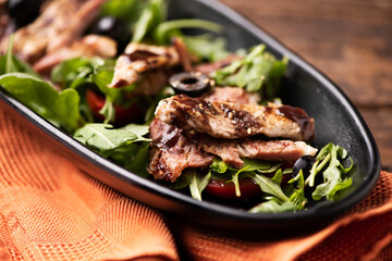 Closeup of healthy salad with grilled chicken fillet, selection of lettuce salad