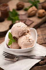 Hazelnut and chocolate icecream in a cup closeup.