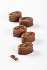 Oval coffee savarin, cake with filling on a white background