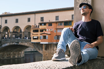 a man with sunglasses and a beret on the Ponte Vecchio