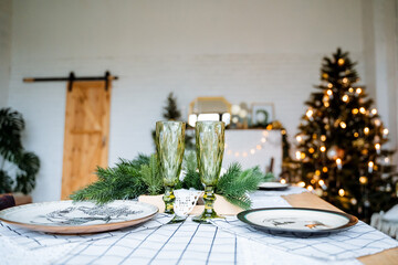 New year and Christmas. Champagne glasses and Gala dinner for two. Preparation for the holiday.Holiday with family, winter holidays.