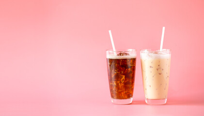 Glasses of blakc coffee and ice coffee milk on pink background. Cold beverages at coffee shop.