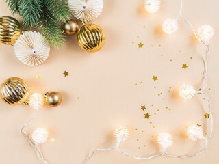 Flat lay of Christmas or New year border. Christmas balls, garland, season decoration on beige background.